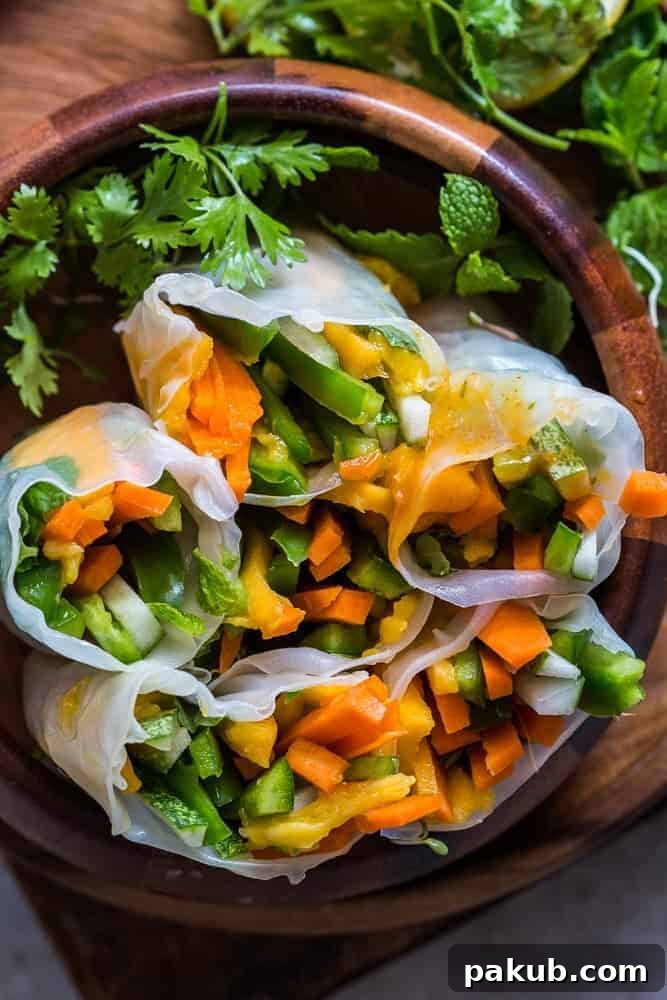 A selection of Mango Bell Pepper Rice Paper Rolls, neatly arranged and ready to be served with the dipping sauce.