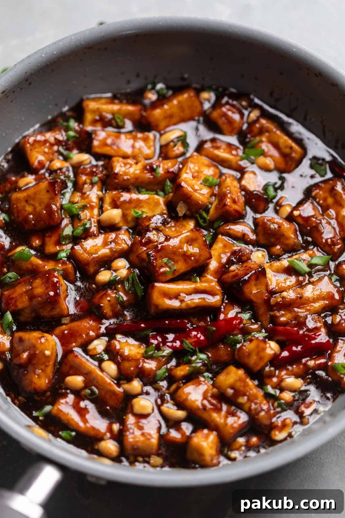 Crispy Air Fryer Kung Pao Tofu 2 A vibrant image of freshly cooked Kung Pao Tofu, glistening in a frying pan, ready to be served.