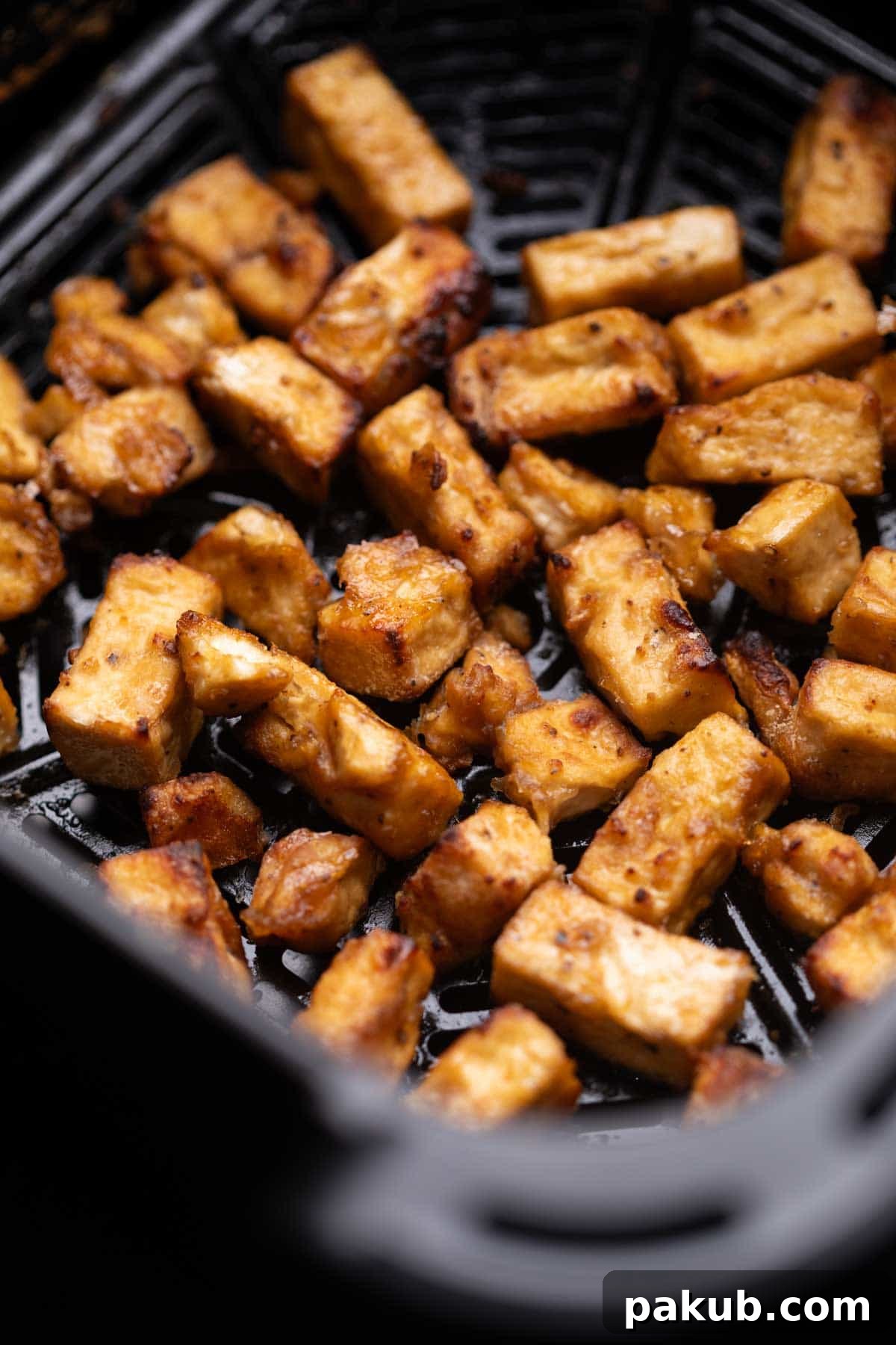 Crispy Air Fryer Kung Pao Tofu 3 Close-up image of perfectly crispy, air-fried tofu cubes, ready to be transformed into Kung Pao Tofu, showcasing their golden-brown exterior.