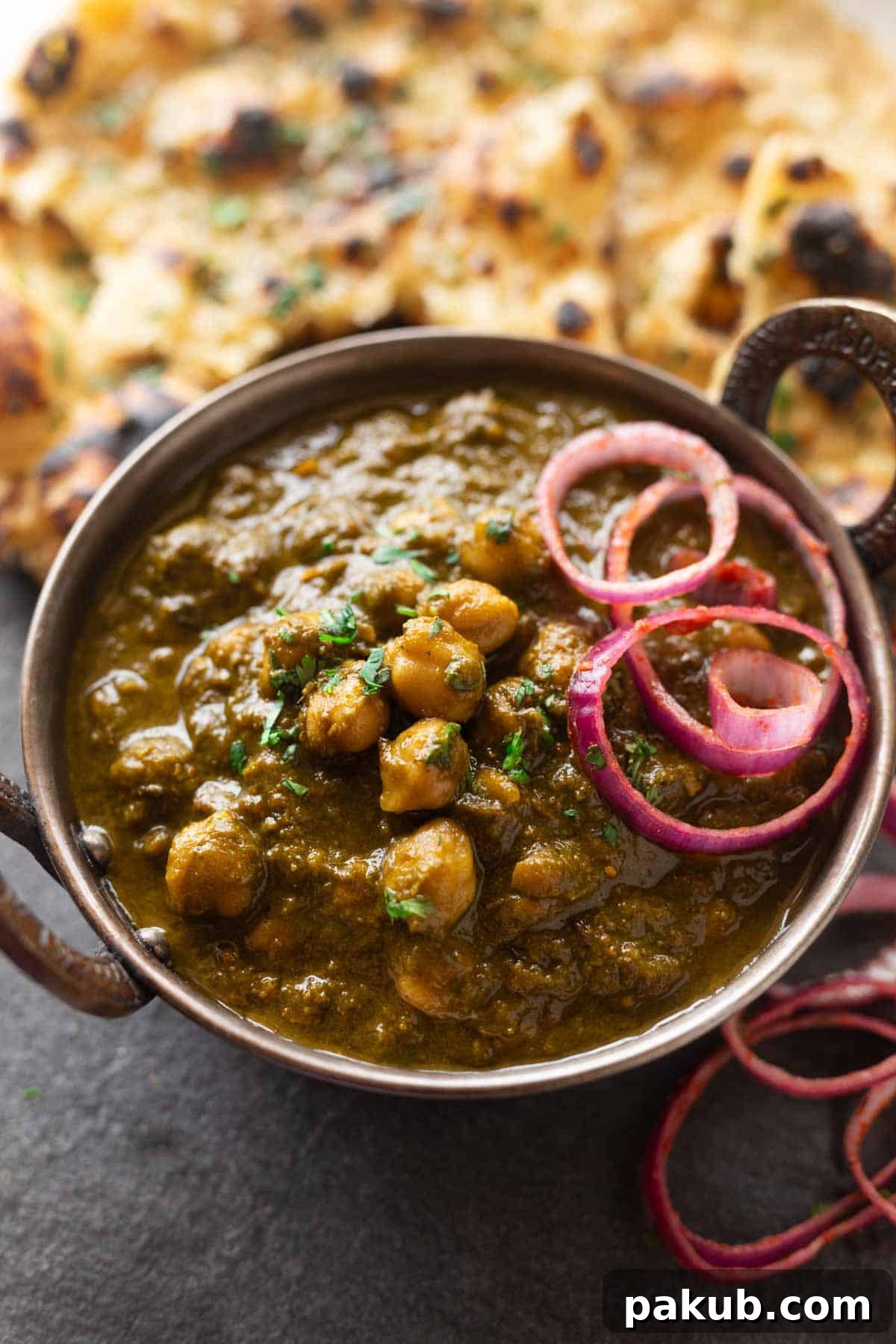 A close-up view of a rich and creamy bowl of Chole Palak, garnished with fresh cilantro, ready to be served.