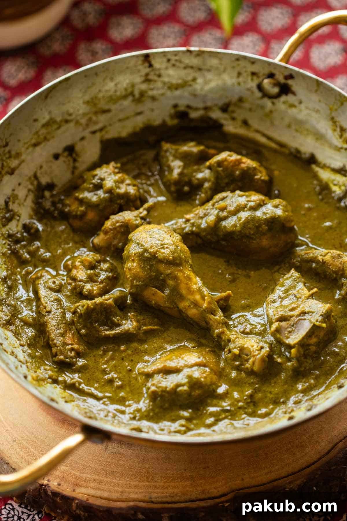 Hariyali Chicken simmering in a traditional Indian kadai, illustrating the rich green gravy and tender chicken pieces.