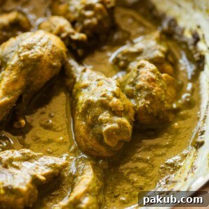 Close-up of Hariyali Chicken showcasing its vibrant green color and tender texture, garnished with fresh herbs.