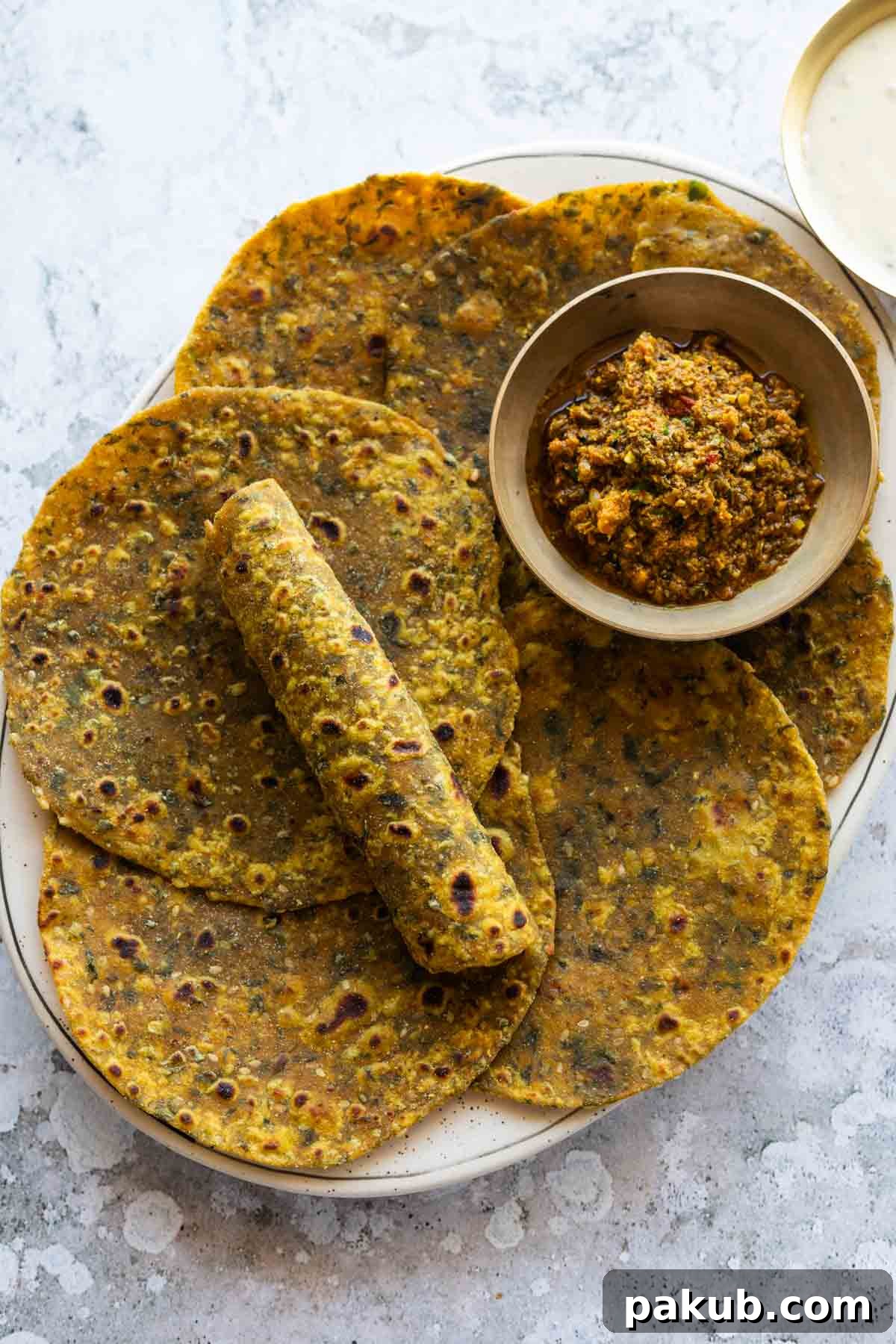 Soft and Spiced Methi Thepla 2 freshly made methi thepla served with pickle