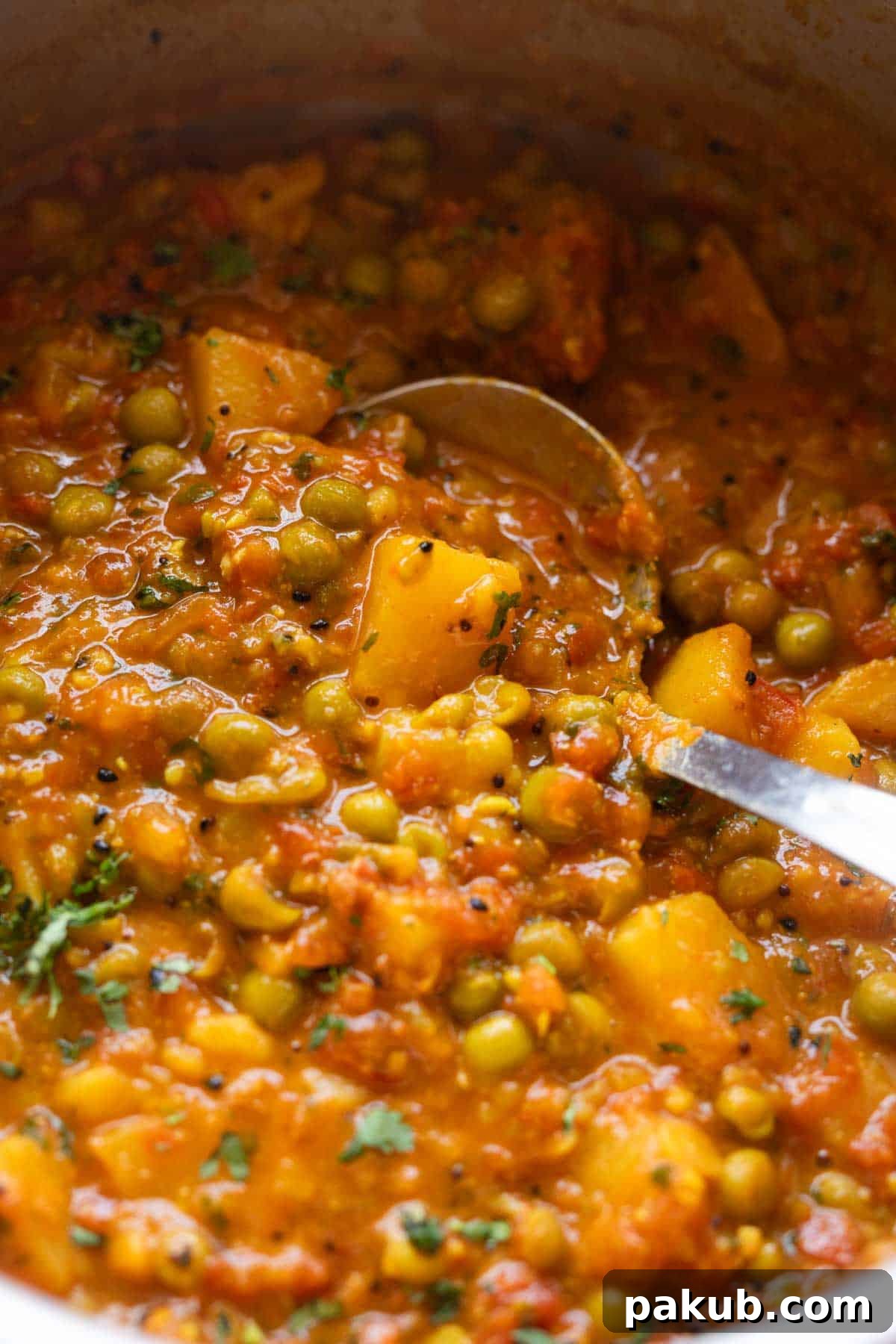 Close-up image of Aloo Matar sabzi to showcase its rich texture and perfect consistency