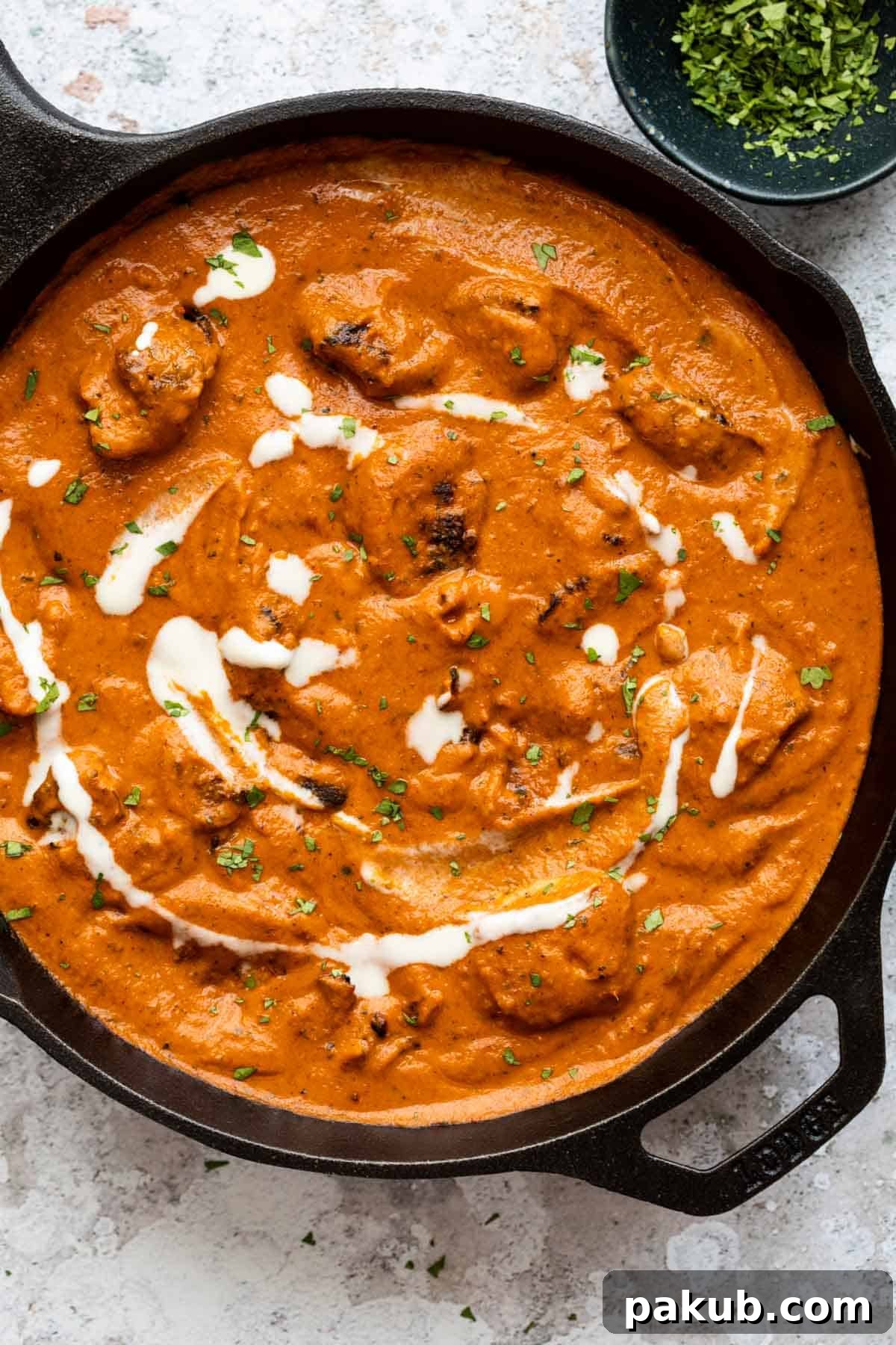 The Ultimate Creamy Butter Chicken 12 Butter chicken served in the pan it was cooked in with some chopped coriander on the side