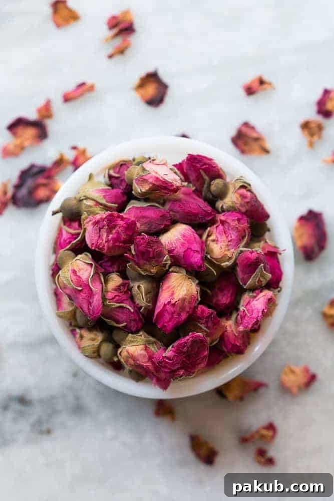 Quick & Easy White and Dark Chocolate Rose Pistachio Bark Recipe Close-up shot of the elegant White and Dark Chocolate Rose Pistachio Bark, highlighting the beautiful contrast between the two chocolates and the vibrant texture of the pistachios and delicate dried rose petals. Ideal for easy homemade desserts.