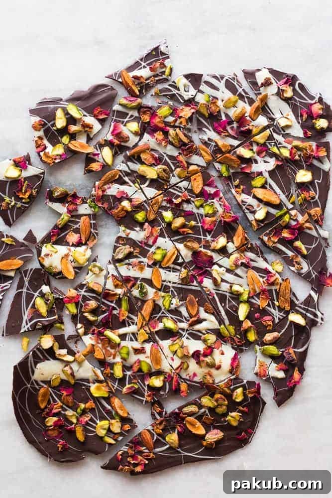 White and Dark Chocolate Rose Pistachio Bark for Elegant Gifting A large, elegant piece of White and Dark Chocolate Rose Pistachio Bark, artfully broken into irregular shards, beautifully arranged and ready for serving or thoughtful gifting.