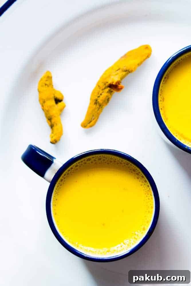 Craft the Perfect Golden Turmeric Milk 3 A vibrant bowl of golden turmeric powder with a traditional Indian mortar and pestle, symbolizing the natural ingredients and heritage of Haldi Doodh.