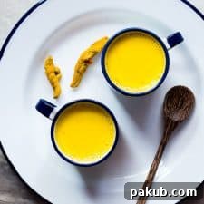 Haldi doodh served in elegant cups on a pristine white plate, exuding warmth and health.
