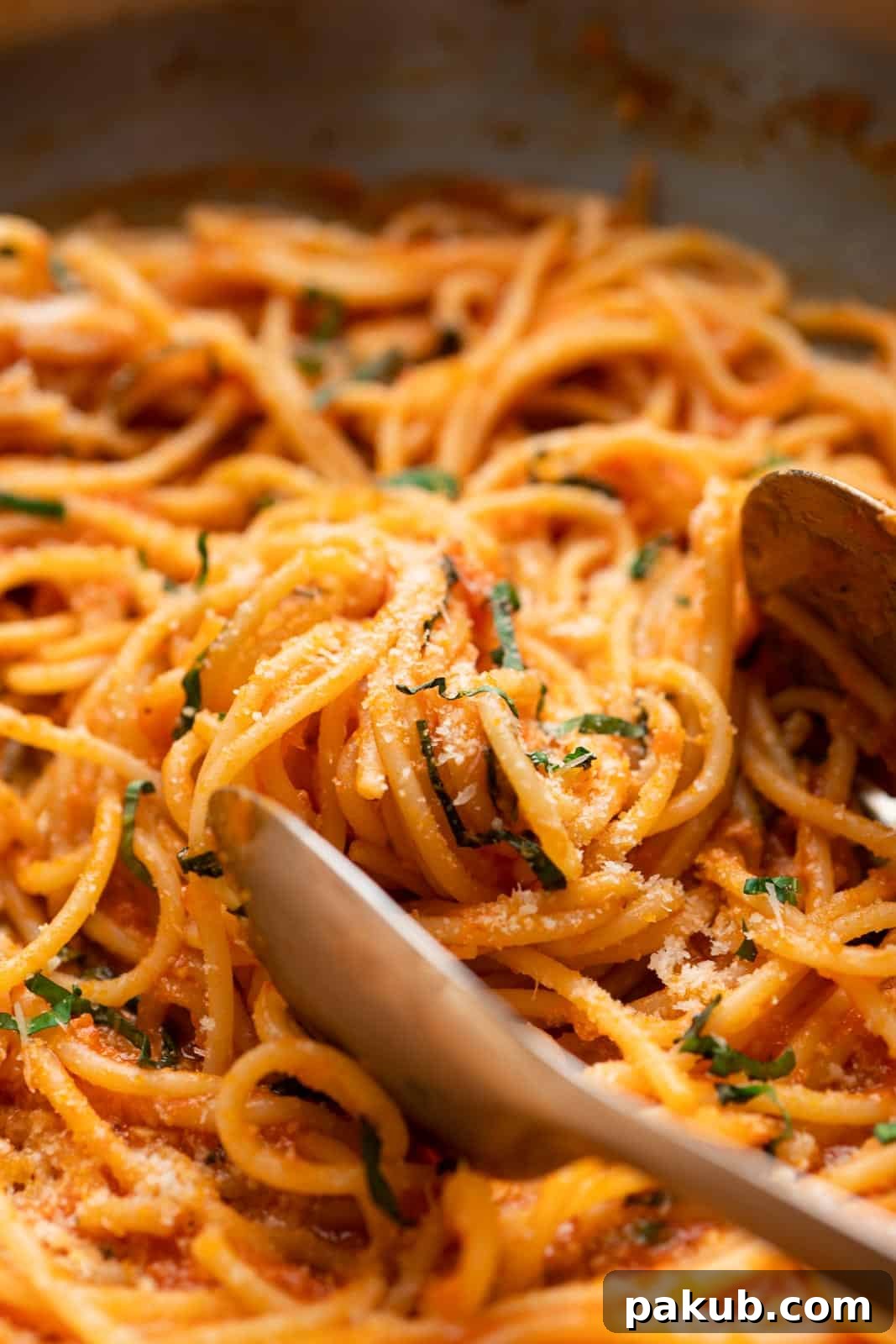Easy Red Pasta Sauce 3 Close-up of freshly cooked spaghetti generously coated with easy homemade red pasta sauce, ready to serve.