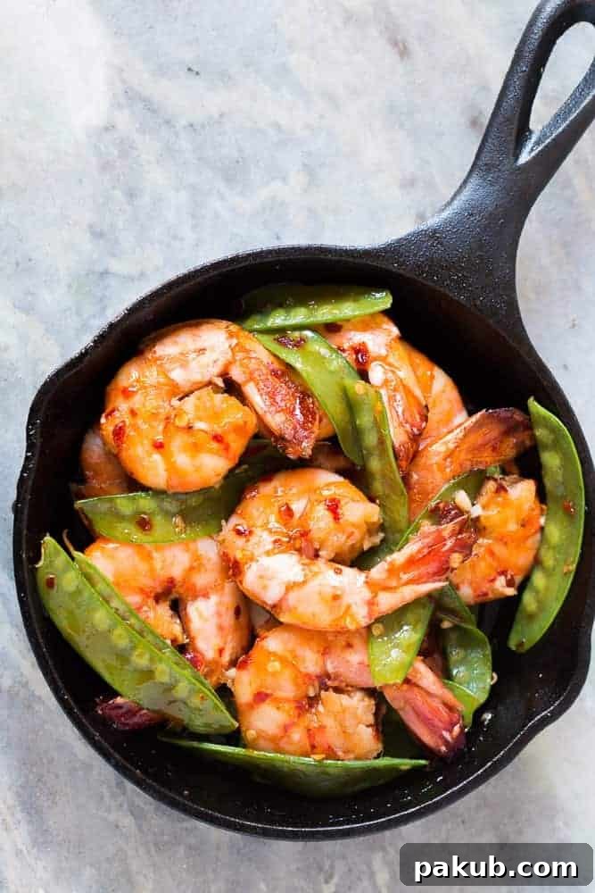 Delicious 5-Ingredient Honey Chilli Garlic Tiger Prawns A vibrant dish of Honey Chilli Garlic Tiger Prawns, showcasing their golden-brown color and the glossy glaze. Perfect for a quick, healthy Asian dinner.