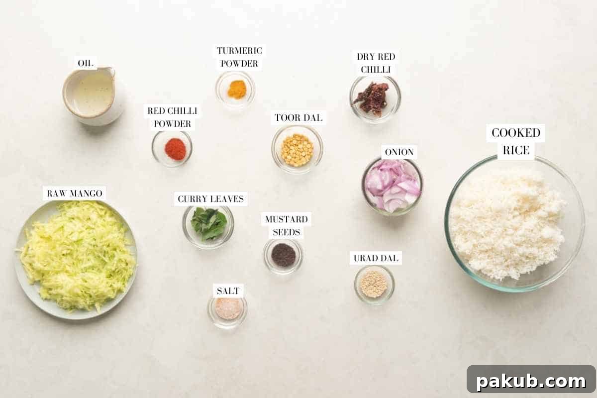 Key Ingredients for Tangy South Indian Mango Rice Raw mango rice ingredients displayed: freshly grated mango, fluffy cooked rice, finely chopped onions, a selection of whole and ground spices, various dals (lentils), and fresh green curry leaves, ready for preparation.
