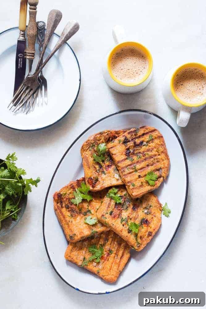 Spicy Indian Masala French Toast with Coffee Vibrantly plated Indian Masala Egg French Toast accompanied by steaming cups of coffee, ready to be enjoyed as a hearty breakfast.