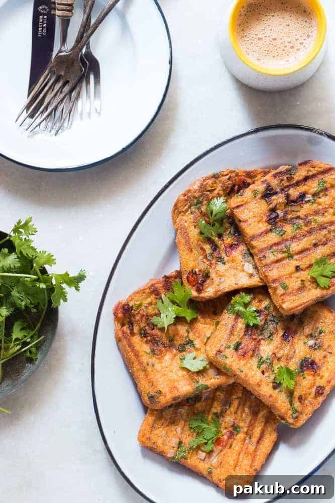 Spicy Egg Toast Platter A generously portioned platter of Indian Masala Egg French Toast, beautifully garnished with fresh coriander, signifying its readiness for serving.