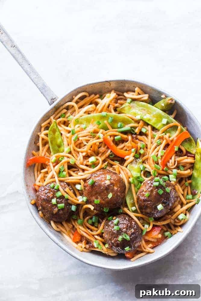 Freshly cooked One-Pan Veg Noodle and Manchurian Stir Fry Close-up of One-Pan Veg Noodle and Manchurian Stir Fry served in a pan, showcasing the noodles and Manchurian balls.