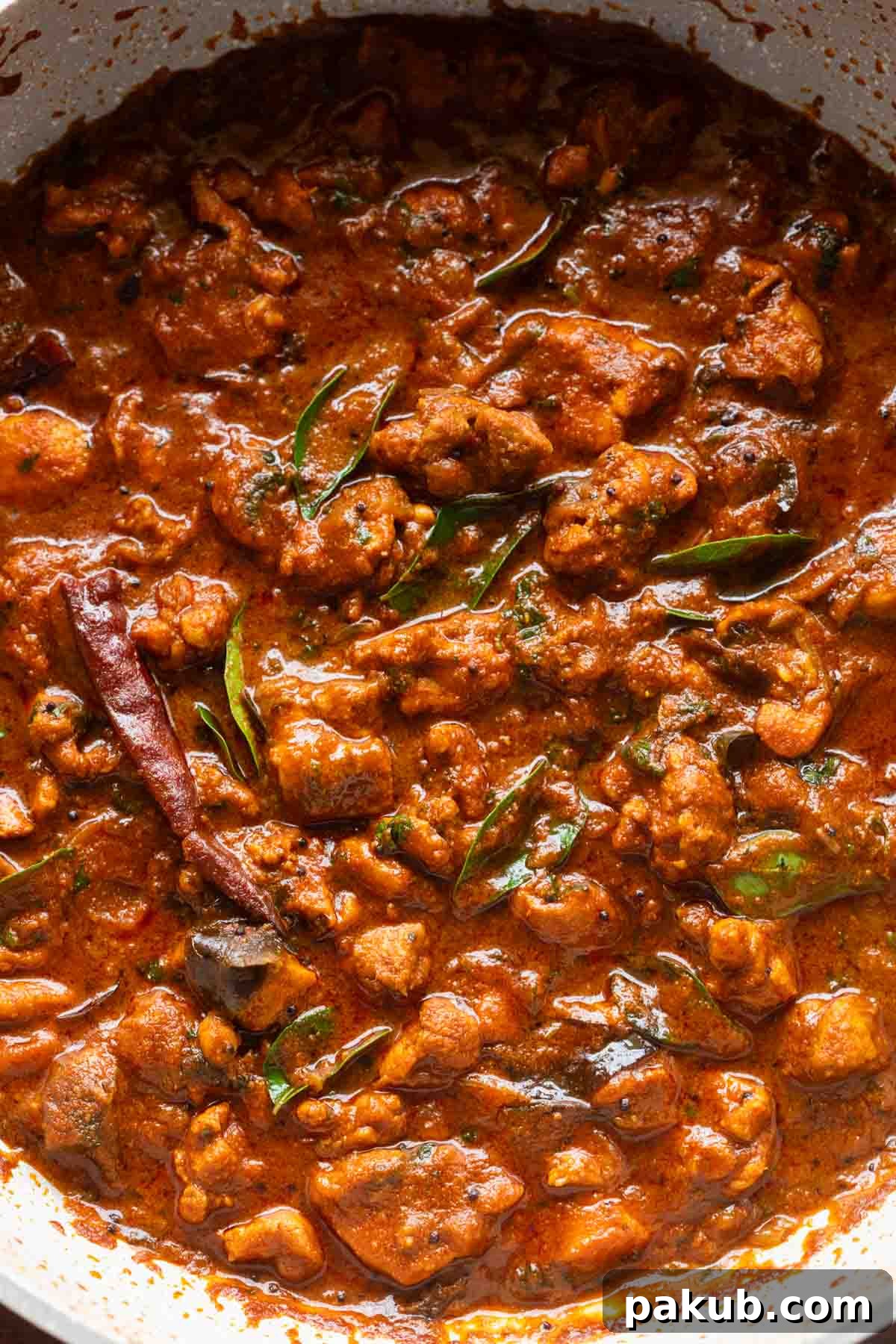 Close-up shot of Chettinad Chicken Curry, showcasing its rich texture and deep color