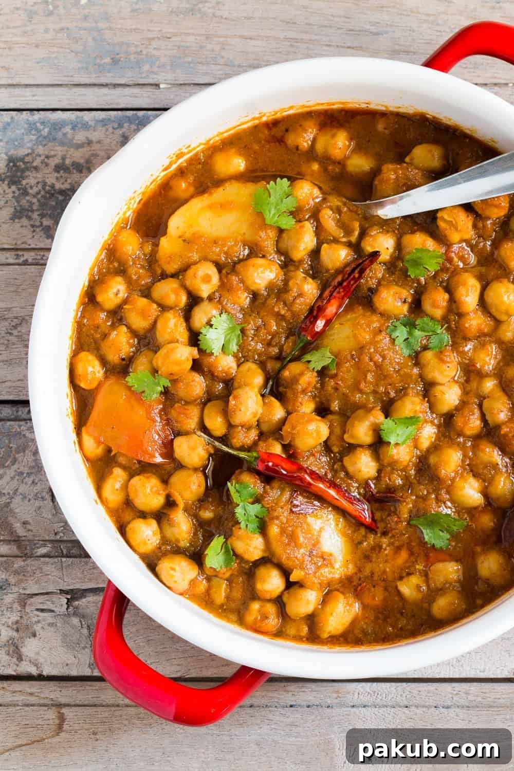 Close-up of Chana Aloo Masala A close-up view of the rich and spicy Chana Aloo Masala, showing the chickpeas and potatoes immersed in gravy.