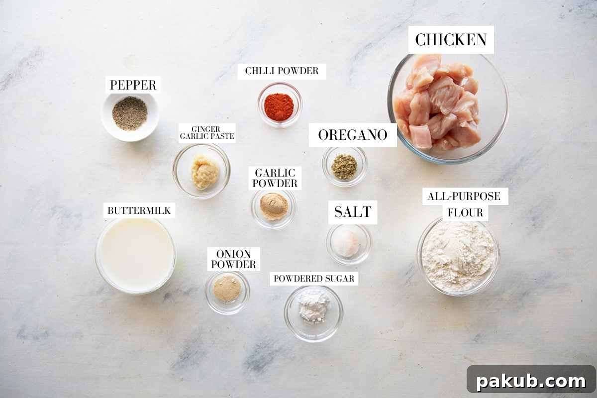 A collage of ingredients laid out on a wooden surface, clearly labeled for making KFC style popcorn chicken. Ingredients include raw chicken pieces, various spices in small bowls, flour, and buttermilk, alongside ginger garlic paste. The image helps visualize the components required.
