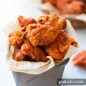 The popcorn chicken served in a mini bucket container.