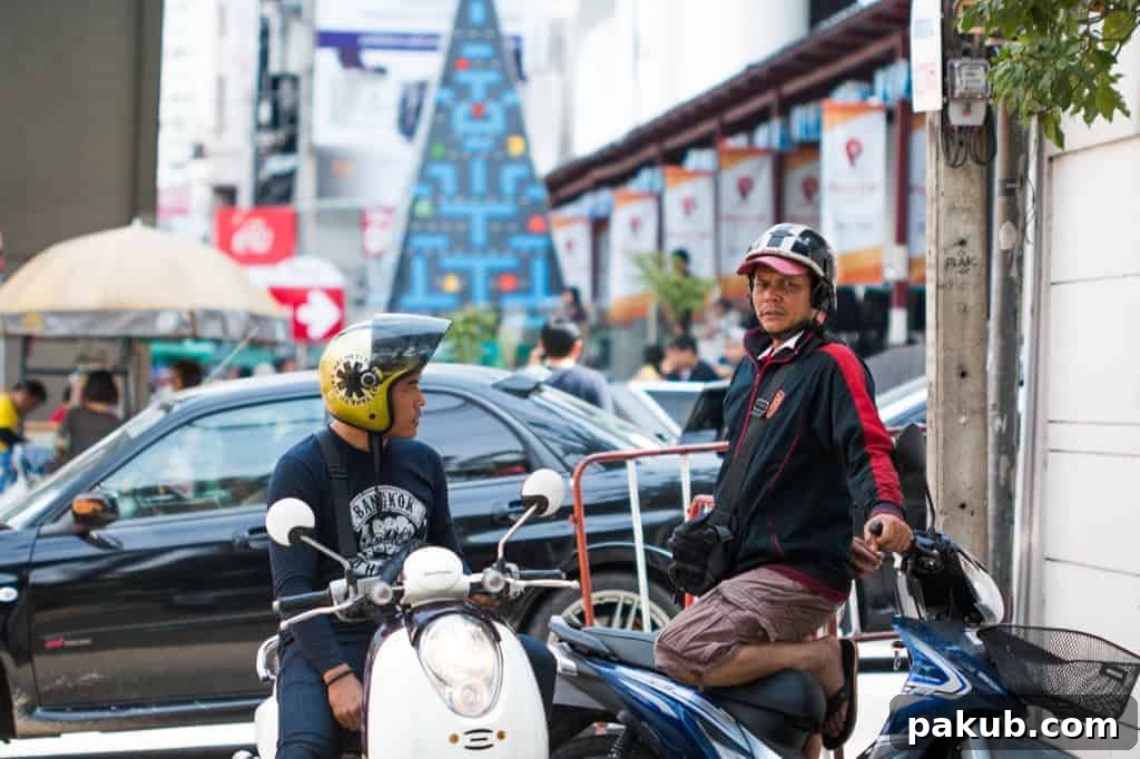 Two men skillfully riding their scooter through a busy, traffic-filled road in Bangkok, capturing the essence of the city's bustling urban commute