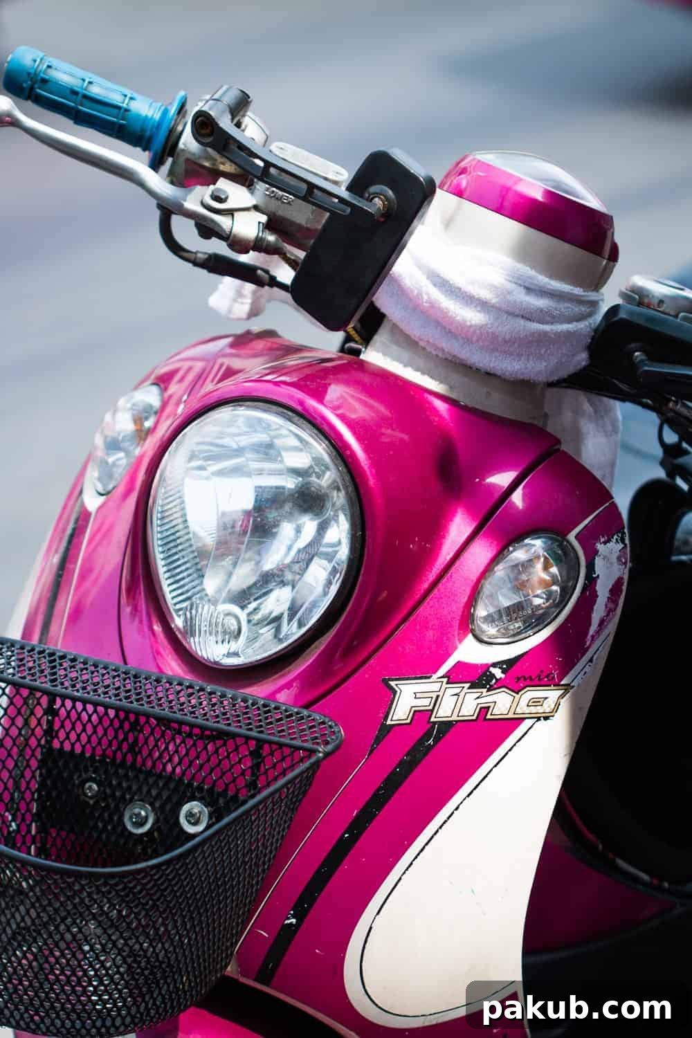 A pristine pink scooter, meticulously parked and gleaming, symbolizing the playful and colorful urban transport scene of Bangkok