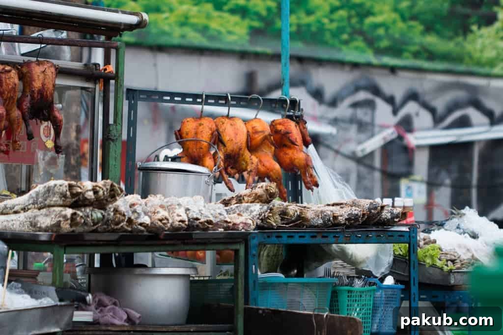 Deliciously cooked chicken skewers, golden-brown and perfectly seasoned, being served as popular street food from a bustling Bangkok stall