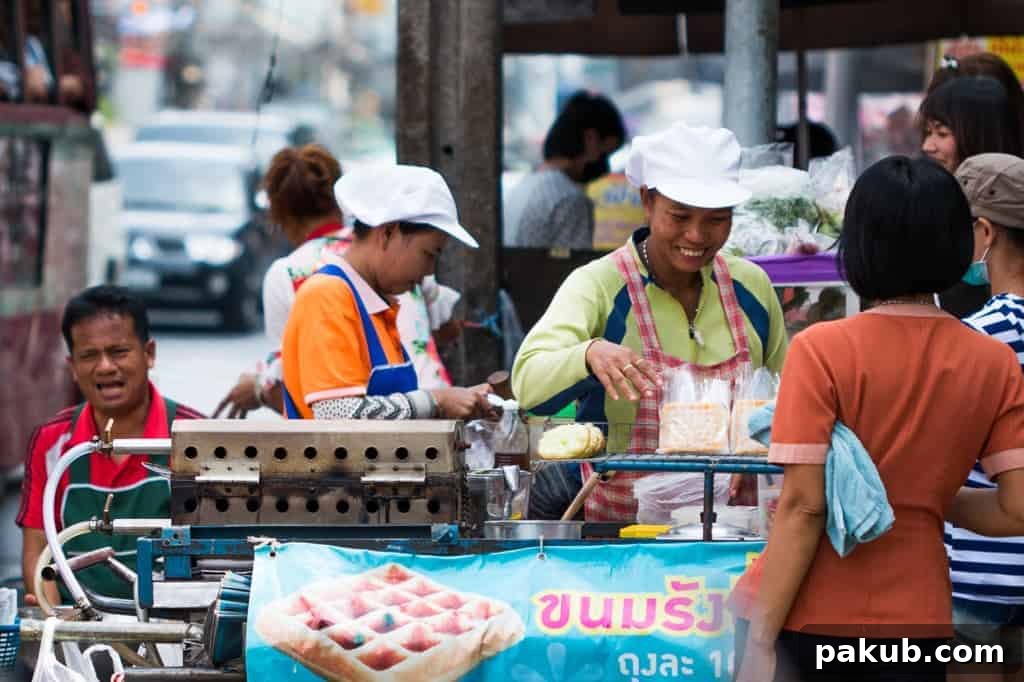 Two enthusiastic local chefs with bright smiles, happily engaging with their customers while skillfully selling and preparing delicious street food from their lively stall