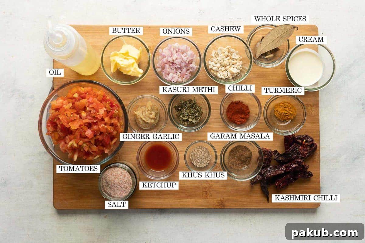 Creamy Restaurant Style Paneer Butter Masala 3 Ingredients for paneer butter masala laid out and labeled on a brown board