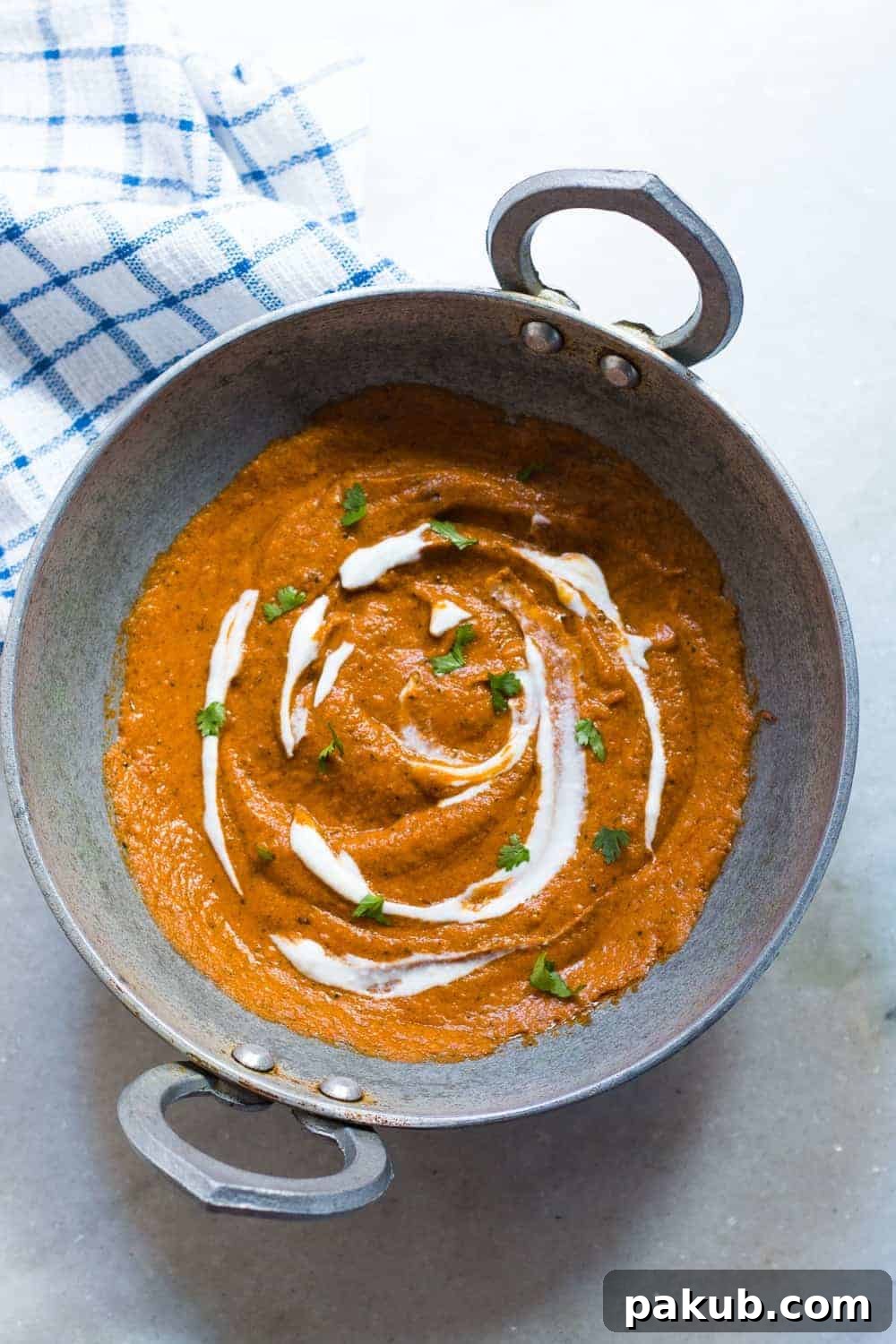 Homemade Makhani Curry Base Close-up of vibrant Indian Makhani Gravy in a karahi pan