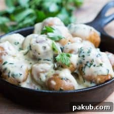 The Creamiest No Mayo Parsley Baby Potatoes in a black skillet.