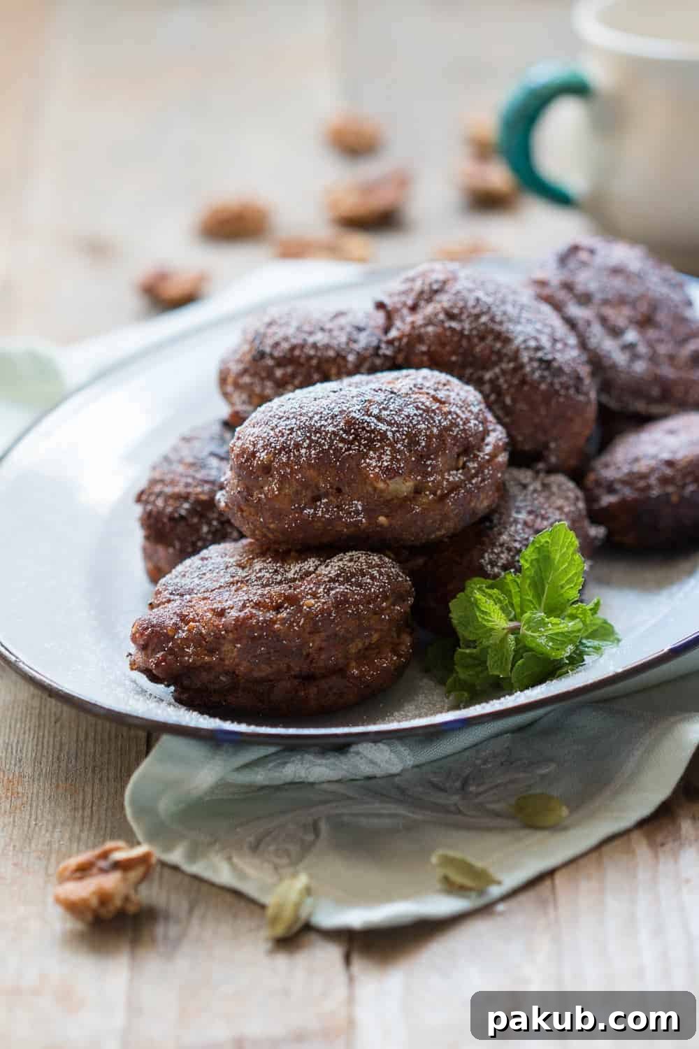 A second view of the Spiced Indian Banana Fritters served on a white plate, garnished with fresh mint leaves.