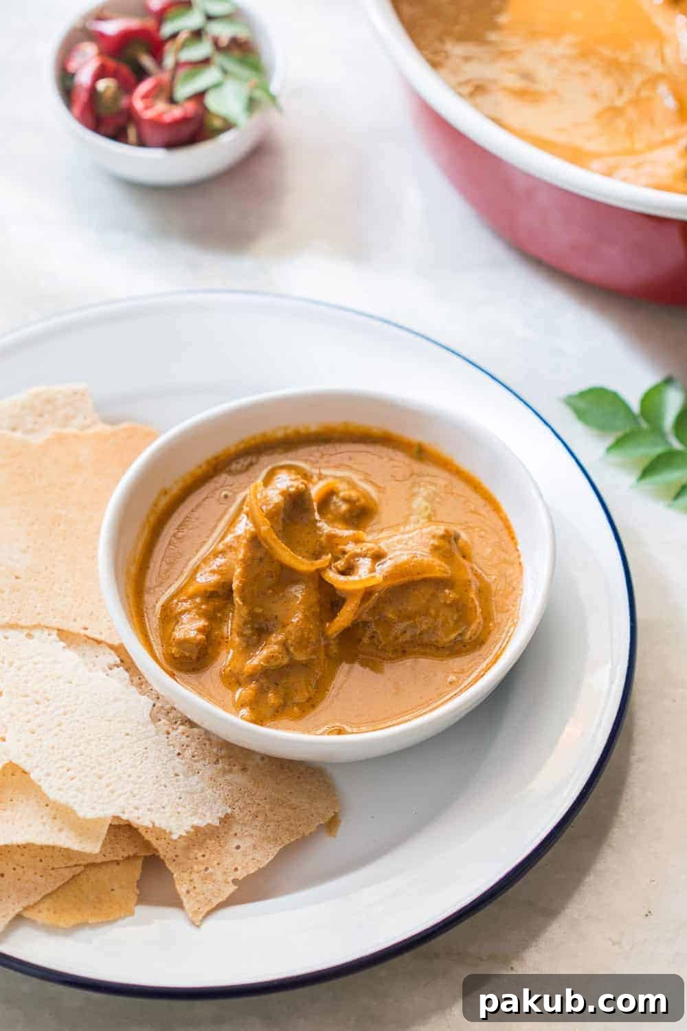Kori Rotti Chicken Curry: A Mangalorean Specialty 2 A beautifully presented Mangalorean chicken curry with crispy rice rotti.