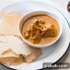 Chicken Kori Rotti served in a white plate.