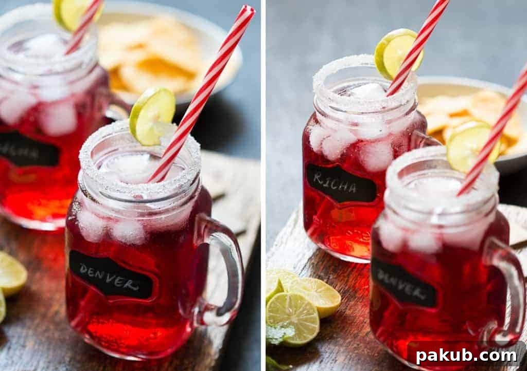 Cranberry Ginger Holiday Cocktail served in mason jars with sugar coated rims and a slice of lime.
