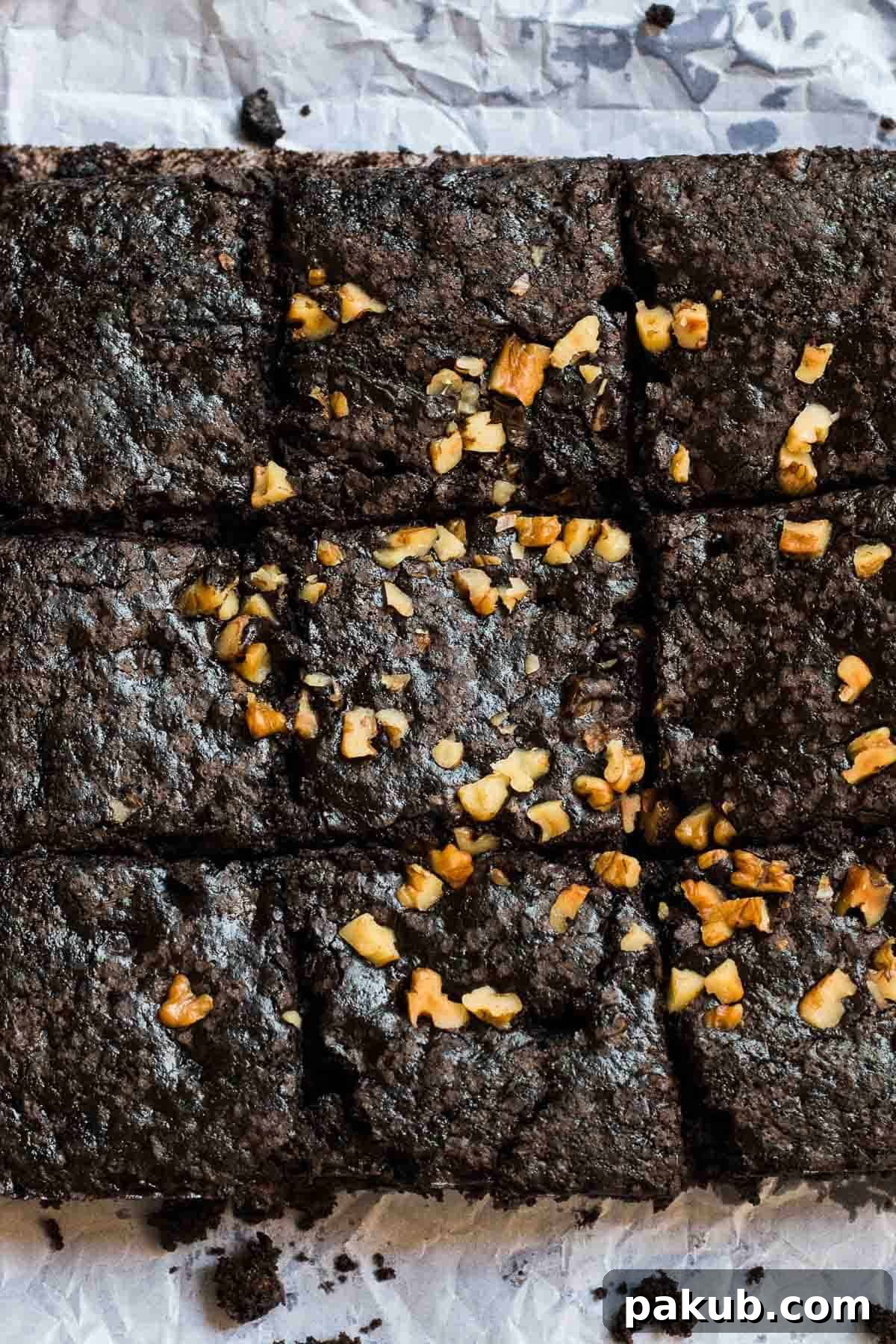 Warm and freshly baked eggless brownies, cooling on a wire rack, ready to be sliced and enjoyed.