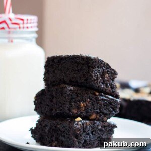 Eggless brownies stacked on top of each other, showcasing their delightful texture.
