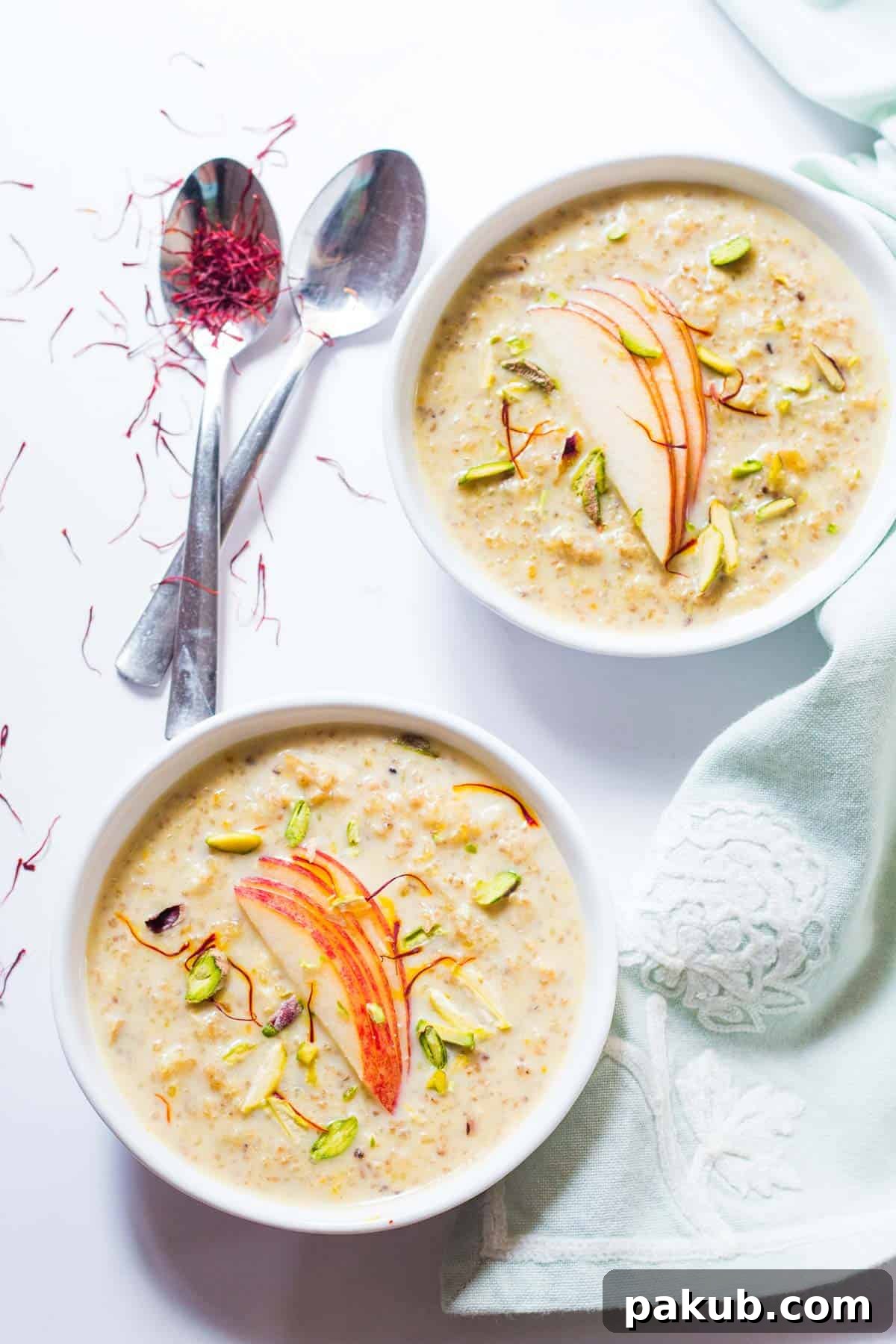 Wholesome Apple Quinoa Pudding 4 Individual white bowls filled with the creamy Healthy Quinoa Apple Kheer, garnished and ready to be enjoyed as a delightful Indian dessert.