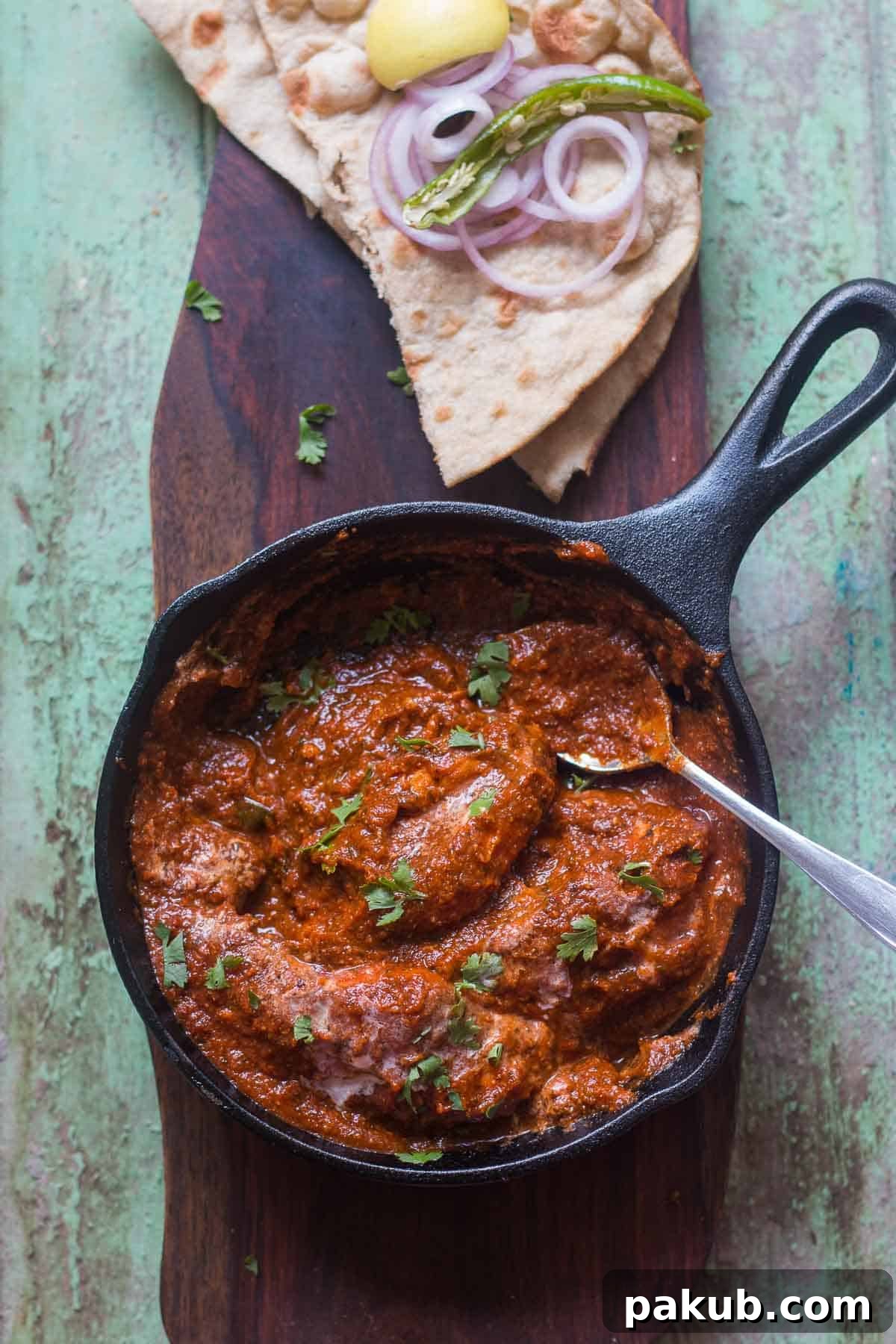 Guilt-Free Chicken Tikka Masala 4 A vibrant and healthy version of Chicken Tikka Masala simmering gently in a non-stick pan, showcasing its deep color and enticing texture.