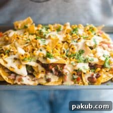 The loaded nachos being served in a tray, capturing the festive and delicious nature of the dish.