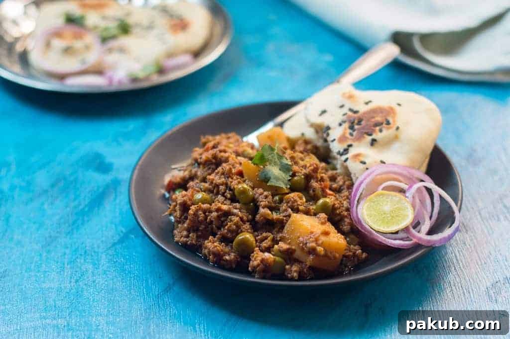 Mutton Keema with Naan Delicious Mutton Keema plated with warm naan bread, fresh chopped onions, and a wedge of lime