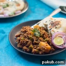 The mutton keema plated with naan, chopped onions and lime.