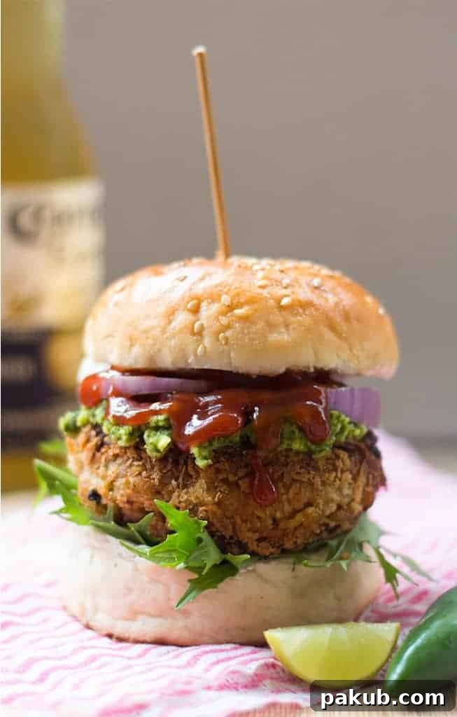 Served Veggie Burgers A plate of fully loaded veggie burgers with avocado mint chutney and a side of fries