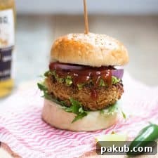 Stacked Veggie Supreme with Refreshing Avocado Mint Chutney 2 The Fully Loaded Veggie Burger with Avocado Mint Chutney served on a wooden board.