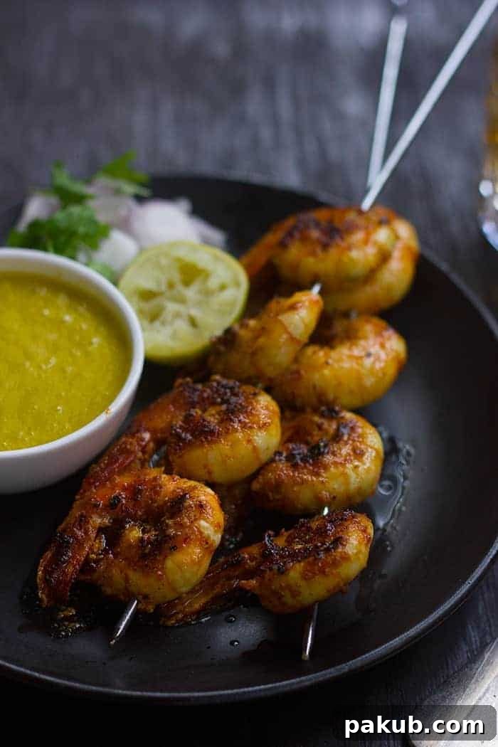 Perfectly Cooked Tandoori Prawns A close-up shot revealing perfectly cooked Tandoori prawns, beautifully charred and glistening, ready to be enjoyed.