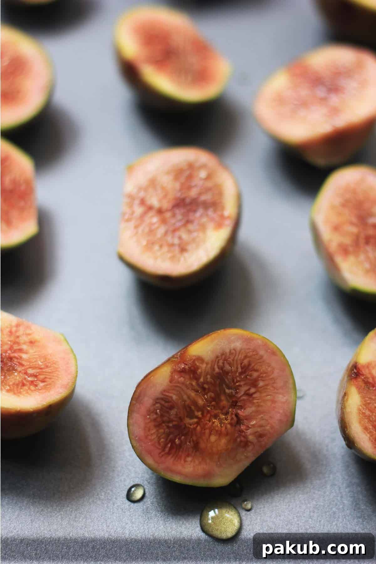 A vibrant selection of fresh, ripe figs, carefully arranged as the primary ingredient for this simple yet elegant dessert.
