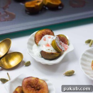 Roasted figs with cardamom yogurt served in small white bowls, ready to be presented and enjoyed as a gourmet dessert.