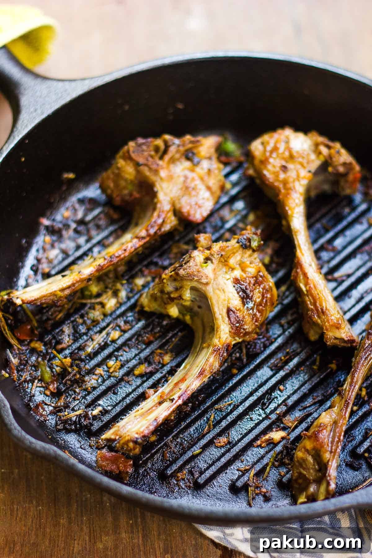 Aromatic Lamb with Fig Balsamic Glaze 2 Spiced lamb chops in a pan, perfectly seared and ready to serve.