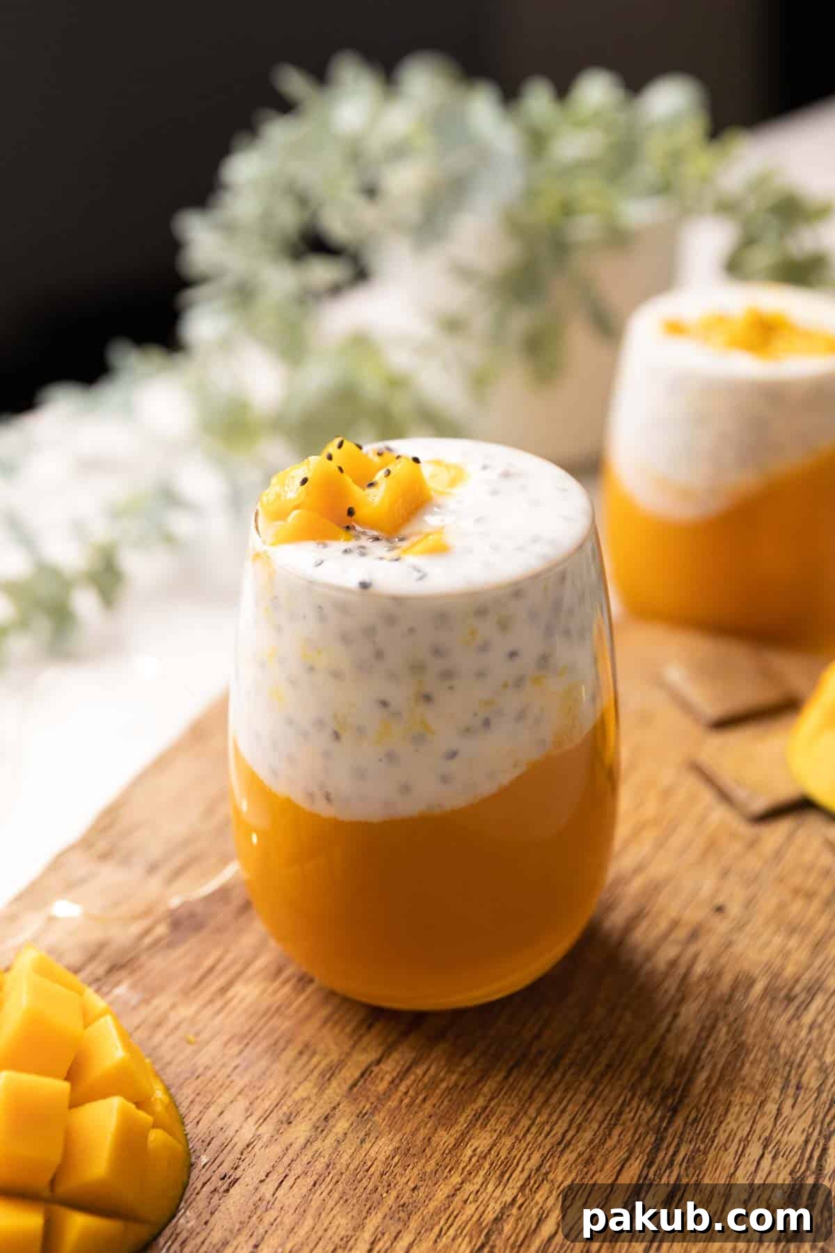 Energizing Mango Chia Breakfast 2 A vibrant Mango Chia Seed Breakfast Drink served in a tall glass, garnished with fresh mint.