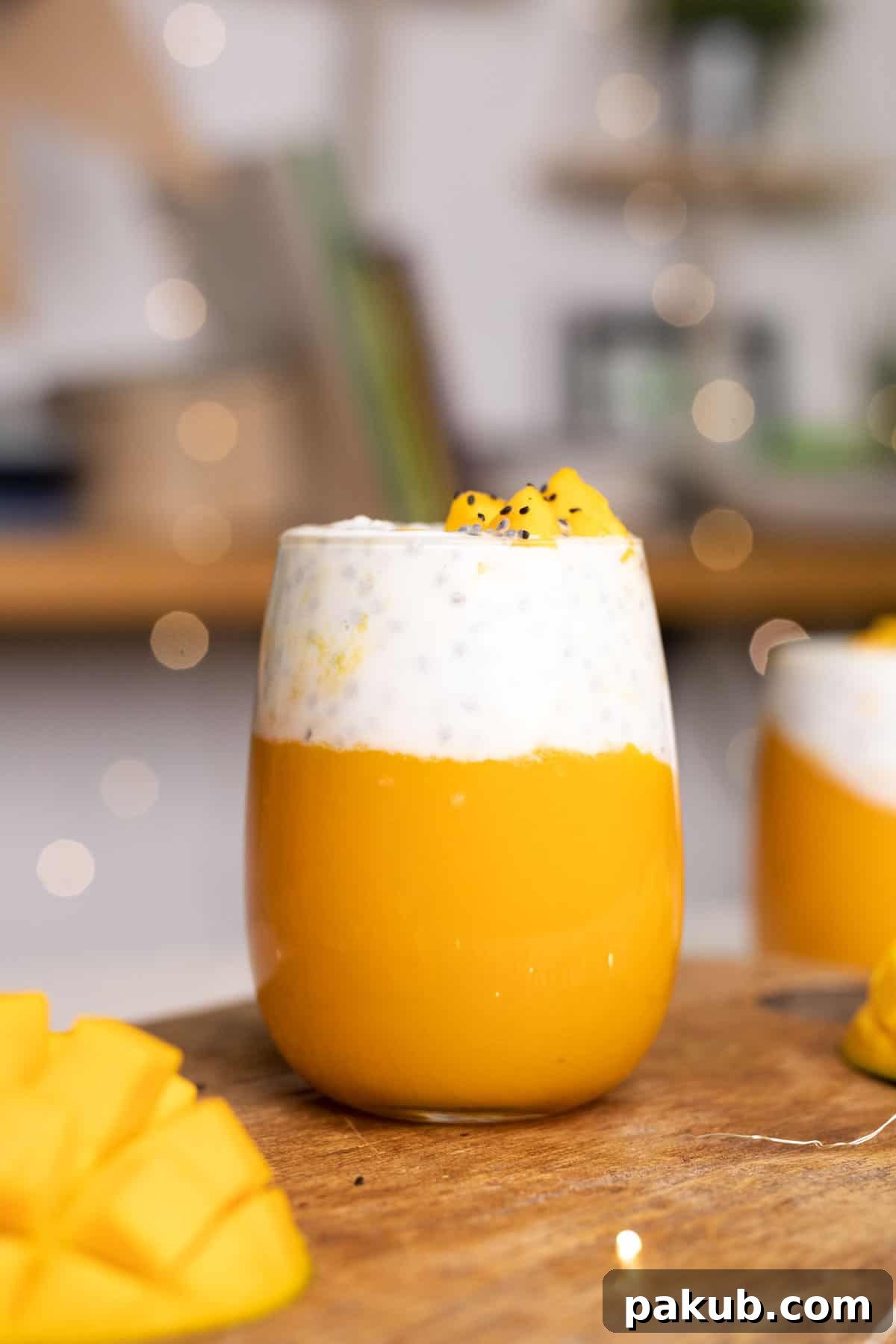 Energizing Mango Chia Breakfast 3 Two glasses of Mango Chia Seed Breakfast Drink, garnished with fresh mint, ready to be enjoyed.
