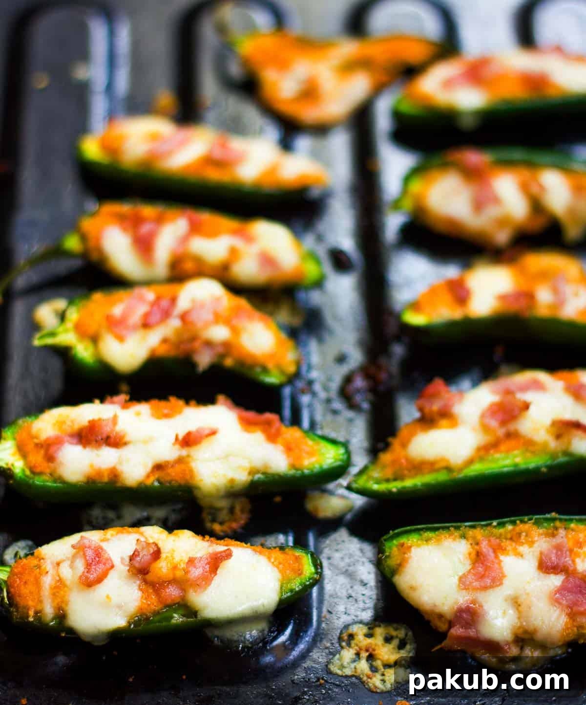 Oven Baked Cottage Jalapeno Delights 2 Freshly baked jalapeno poppers, golden and bubbly, right out of the oven, garnished with fresh herbs.